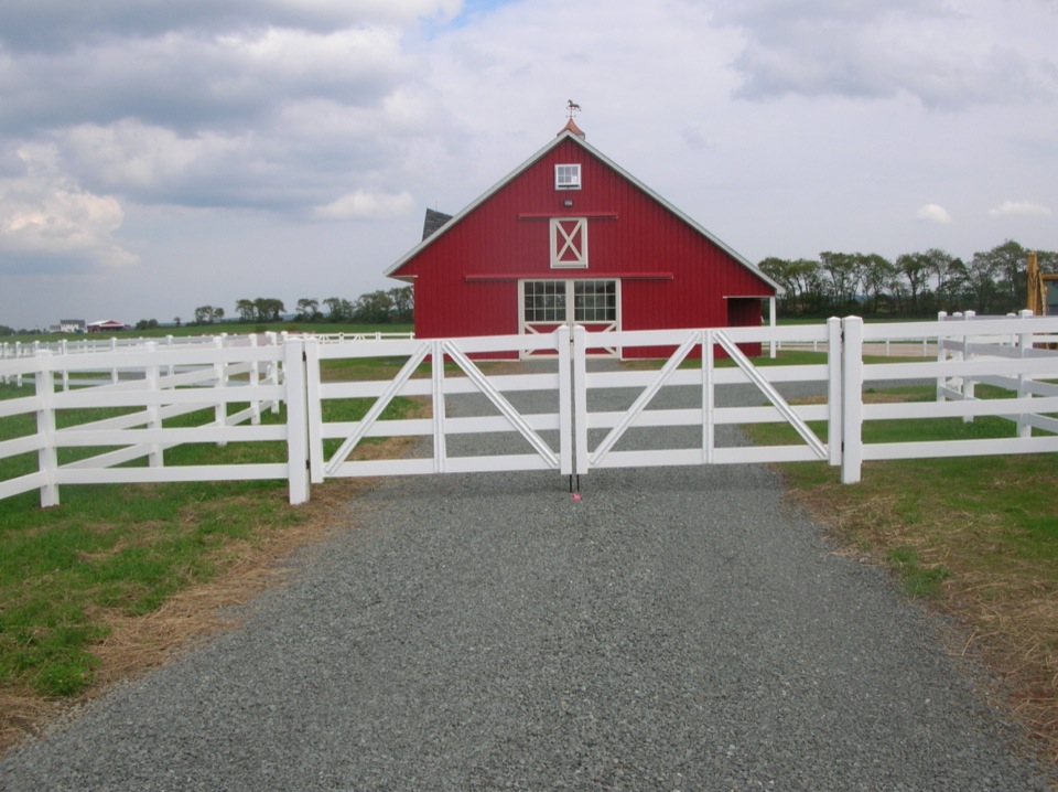 Red Barn with White Fence in Foreground