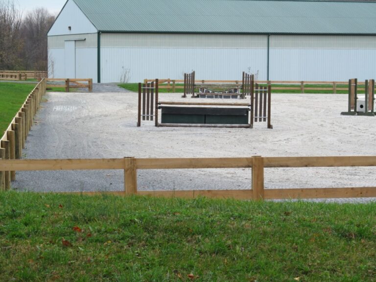 wooden fence around horse arena