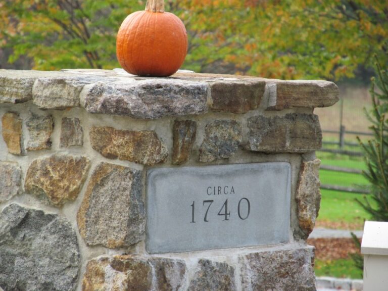Pumpkin on top of stone wall